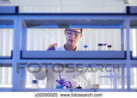 Scientist in laboratory using electronic pipette View Large Photo Image Stock Photography - Scientist in laboratory using electronic pipette. Fotosearch