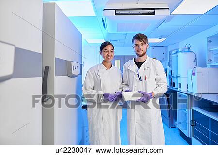 Scientists in laboratory looking at camera View Large Photo Image Stock Photo - Scientists in laboratory looking at camera. Fotosearch