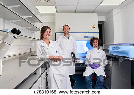 Scientists in laboratory looking at camera smiling View Large Photo Image Stock Photo - Scientists in laboratory looking at camera smiling. Fotosearch