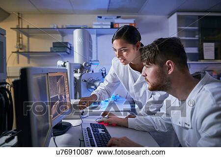 Stock Photo - Scientists in laboratory using computer. Fotosearch