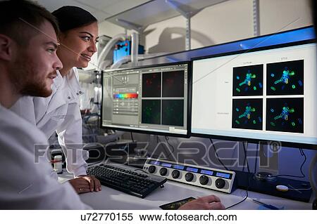 Stock Photography - Scientists in laboratory using computer. Fotosearch