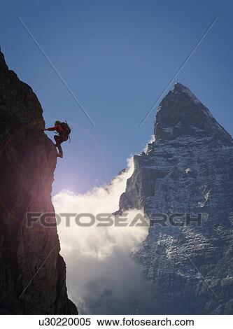 Silhouetted female climber climbing rock face near Matterhorn, Canton Wallis, Switzerland View Large Photo Image Stock Photography - Silhouetted female climber climbing rock face near Matterhorn, Canton Wallis, Switzerland. Fotosearch
