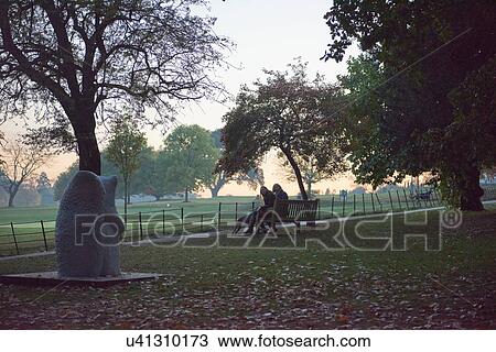 Silhouetted view of senior woman and daughter sitting on park bench in autumn park View Large Photo Image Stock Image - Silhouetted view of senior woman and daughter sitting on park bench in autumn park. Fotosearch