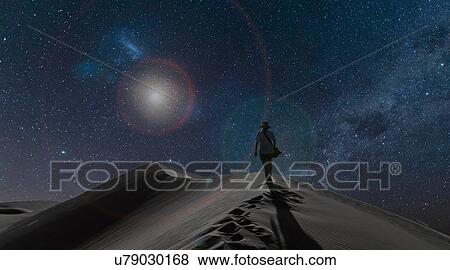 Silhouetted view of woman on dunes under starry night sky, Namib Desert, Namibia View Large Photo Image Stock Photo - Silhouetted view of woman on dunes under starry night sky, Namib Desert, Namibia. Fotosearch