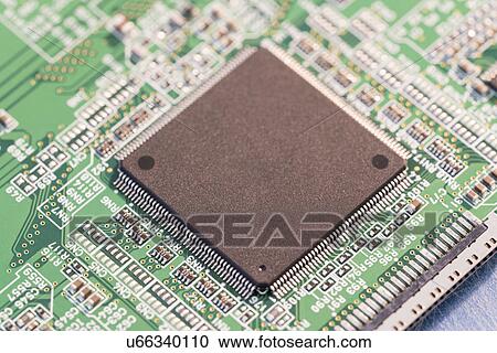 Stock Image - Silicon chip on a circuit board microprocessor. Fotosearch