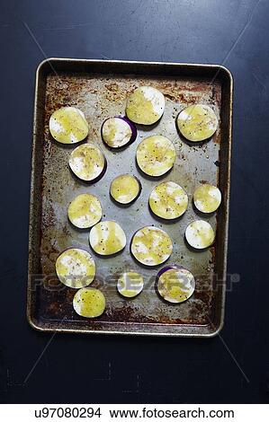 Picture - Sliced eggplant in baking sheet. Fotosearch