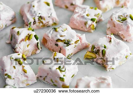 Stock Photograph - Sliced pistachio and rose nougat. Fotosearch