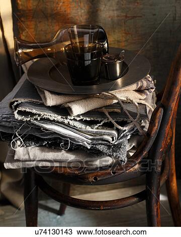 Stacked tablecloths and tray on bistro chair View Large Photo Image Stock Image - Stacked tablecloths and tray on bistro chair. Fotosearch