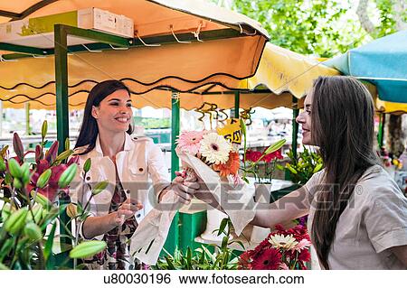 Stall holder handing female tourist bunch of flowers at market stall, Split, Dalmatia, Croatia View Large Photo Image Stock Photograph - Stall holder handing female tourist bunch of flowers at market stall, Split, Dalmatia, Croatia. Fotosearch