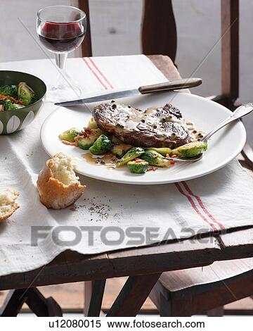 Steak with green pepper sauce, brussels sprouts and bacon View Large Photo Image Stock Photography - Steak with green pepper sauce, brussels sprouts and bacon. Fotosearch