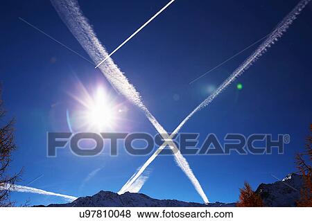 Stock Photo - Steam trails in sky, Schluderns, South Tyrol, Italy. Fotosearch
