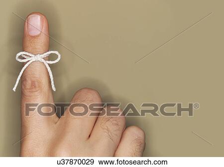 String bow tied on finger View Large Photo Image Stock Photo - String bow tied on finger. Fotosearch