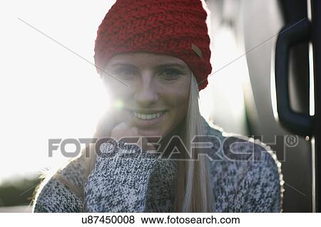 Sunlit portrait of young woman in red knit hat View Large Photo Image Stock Photo - Sunlit portrait of young woman in red knit hat. Fotosearch