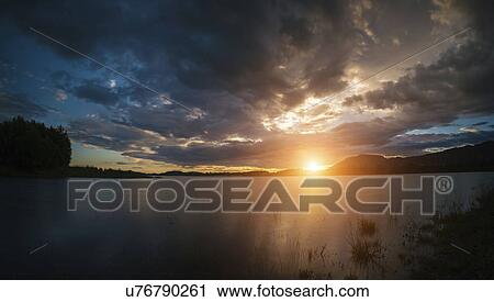 Stock Image - Sunset over lake. Fotosearch