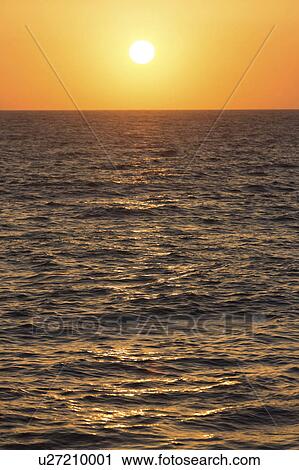 Stock Image - Sunset over the sea. Fotosearch