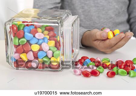 Stock Photography - Sweets spilling onto table. Fotosearch