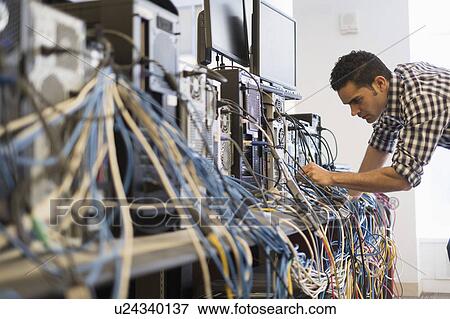 Tangled cables with young technician man in background View Large Photo Image Stock Photo - Tangled cables with young technician man in background. Fotosearch