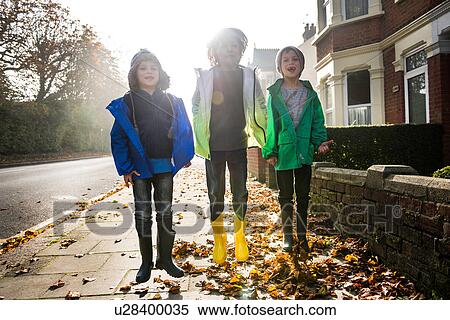 Three boys, outdoors, jumping in street View Large Photo Image Stock Photography - Three boys, outdoors, jumping in street. Fotosearch