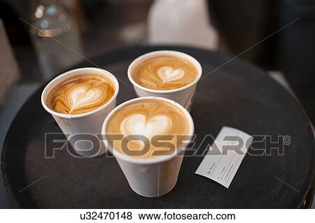 Three takeaway cups of coffee with heart shaped tops View Large Photo Image Stock Photo - Three takeaway cups of coffee with heart shaped tops. Fotosearch