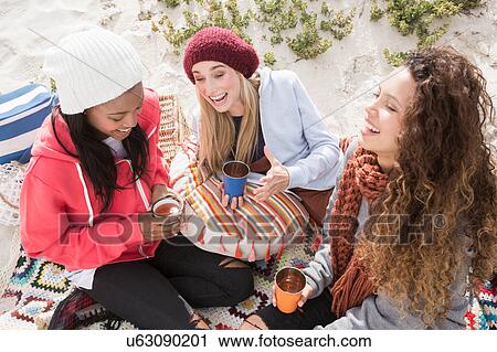 Three young women laughing on beach picnic, Western Cape, South Africa View Large Photo Image Stock Image - Three young women laughing on beach picnic, Western Cape, South Africa. Fotosearch