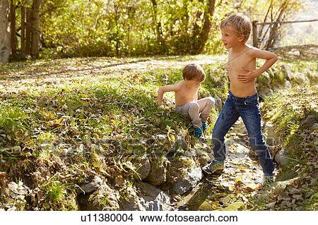 Two boys exploring outdoors, Schluderns, South Tyrol, Italy View Large Photo Image Picture - Two boys exploring outdoors, Schluderns, South Tyrol, Italy. Fotosearch