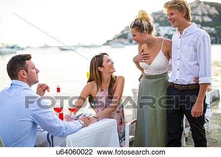 Two couples greeting at waterfront restaurant, Majorca, Spain View Large Photo Image Stock Image - Two couples greeting at waterfront restaurant, Majorca, Spain. Fotosearch