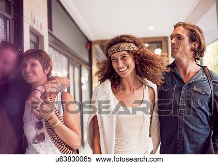 Two couples strolling by city shops View Large Photo Image Stock Photography - Two couples strolling by city shops. Fotosearch