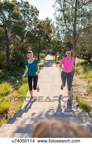 Two female runners running in park, Split, Dalmatia, Croatia View Large Photo Image Picture - Two female runners running in park, Split, Dalmatia, Croatia. Fotosearch