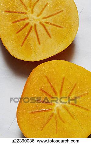 Stock Photograph - Two half of Persimmon. Fotosearch