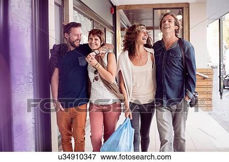 Two shopping couples strolling by city shops View Large Photo Image Stock Photo - Two shopping couples strolling by city shops. Fotosearch