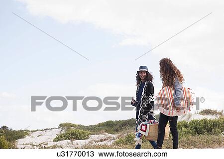 Two young female friends strolling on beach, Western Cape, South Africa View Large Photo Image Stock Image - Two young female friends strolling on beach, Western Cape, South Africa. Fotosearch