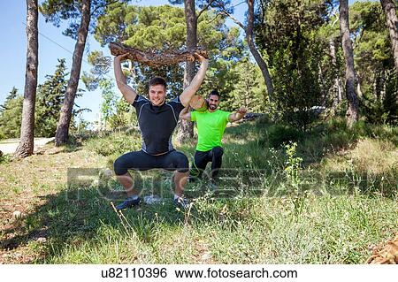 Two young men doing weightlifting training with logs in forest, Split, Dalmatia, Croatia View Large Photo Image Stock Photograph - Two young men doing weightlifting training with logs in forest, Split, Dalmatia, Croatia. Fotosearch