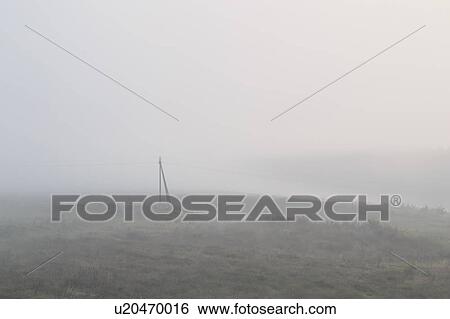 Ukraine, Dnepropetrovsk region, Novomoskovsk district, Electricity pylon standing in foggy field View Large Photo Image Stock Photograph - Ukraine, Dnepropetrovsk region, Novomoskovsk district, Electricity pylon standing in foggy field. Fotosearch