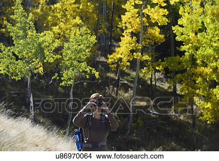 Picture - USA, Colorado, Kenosha Pass, Senior woman photographing at Kenosha Pass. Fotosearch