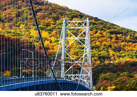 Stock Image - USA, New York, Bear Mountain with bridge above river. Fotosearch