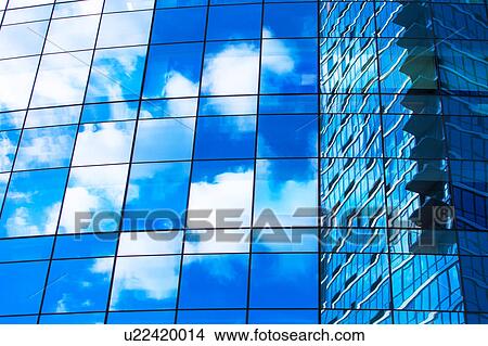 Picture - USA, New York, Clouds reflecting in glassy office building. Fotosearch