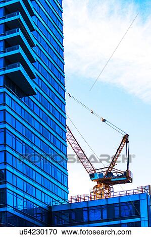 USA, New York, Crane by office building View Large Photo Image Stock Image - USA, New York, Crane by office building. Fotosearch