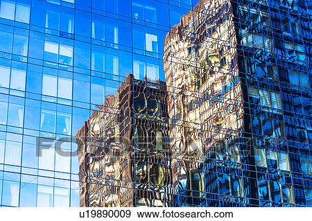Stock Photo - USA, New York, Distorted reflections in glass building. Fotosearch