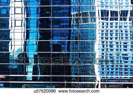 Stock Photograph - USA, New York, Distorted reflections in office building. Fotosearch