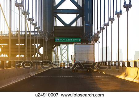 Stock Photo - USA, New York, New York City, Semi- truck on Brooklyn Bridge. Fotosearch