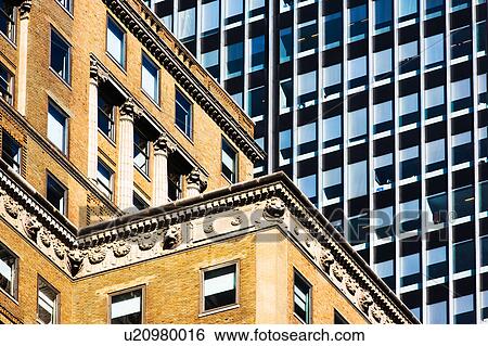 Stock Photograph - USA, New York, Old building and modern office block behind. Fotosearch