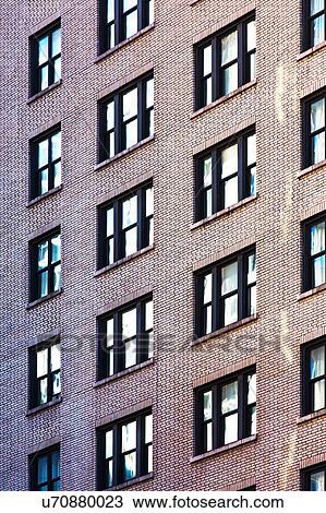 Stock Image - USA, New York, Row of windows in high building. Fotosearch
