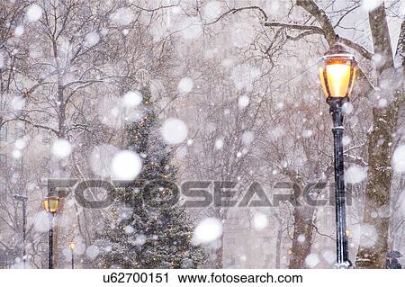 Stock Image - USA, New York State, New York City, Madison Square Park in snow. Fotosearch