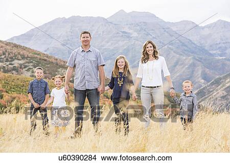 USA, Utah, Provo, Family with three children (4-5, 6-7, 8-9) standing in field View Large Photo Image Picture - USA, Utah, Provo, Family with three children (4-5, 6-7, 8-9) standing in field. Fotosearch