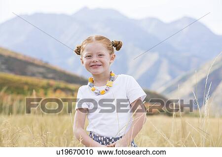 Stock Image - USA, Utah, Provo, Girl (4-5) standing in field. Fotosearch