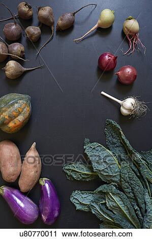 Stock Image - Vegetables on dark surface. Fotosearch