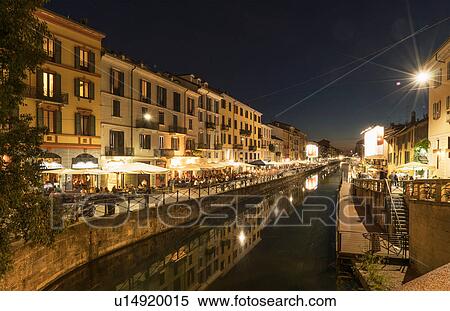 Stock Photography - View of canal waterfront in Navigli district at night, Milan, Italy. Fotosearch