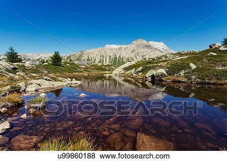 Stock Photo - View of lake and mountains, Albula Pass, Graubunden, Switzerland. Fotosearch