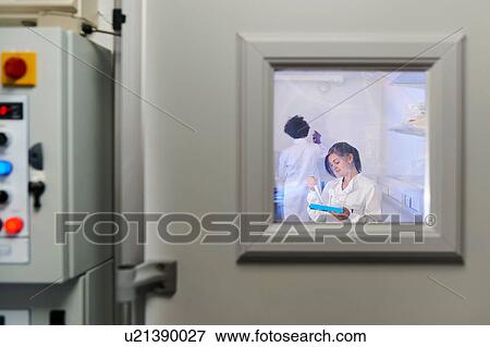 Stock Photo - View through window of scientists in laboratory. Fotosearch