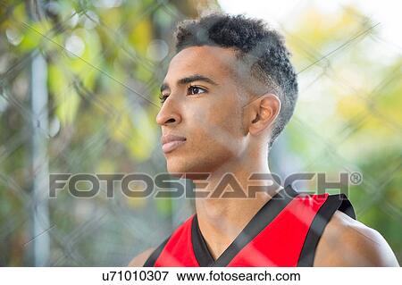 View through wire fence of young male athlete View Large Photo Image Stock Photo - View through wire fence of young male athlete. Fotosearch